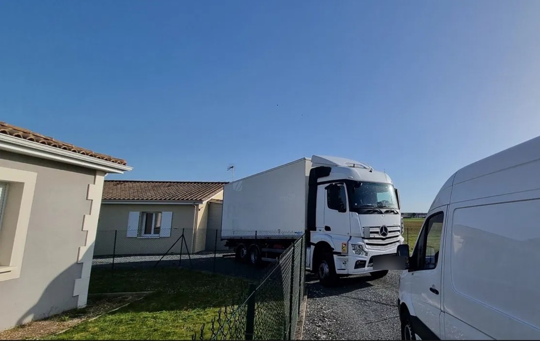 Camion Rivage Transport garé devant une maison lors d'une livraison
